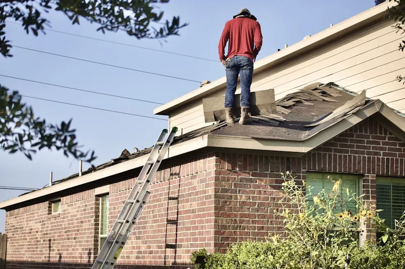 Professional roofer working on a residential roof in Montville Center